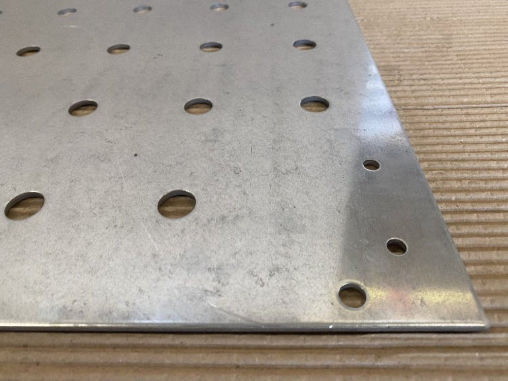Detalj av galvaniserad bottenplatta med perforerade hål