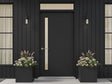 Blomlådor i svart stål med blommande växter vid entré