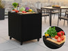byJEMA uteköksbord i svartlackerat stål med hjul på modern takterrass med grönsaker och skärbräda