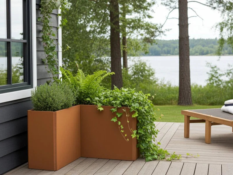 EDGY hög vinkelformad blomlåda i cortenstål med grön plantering på terrass