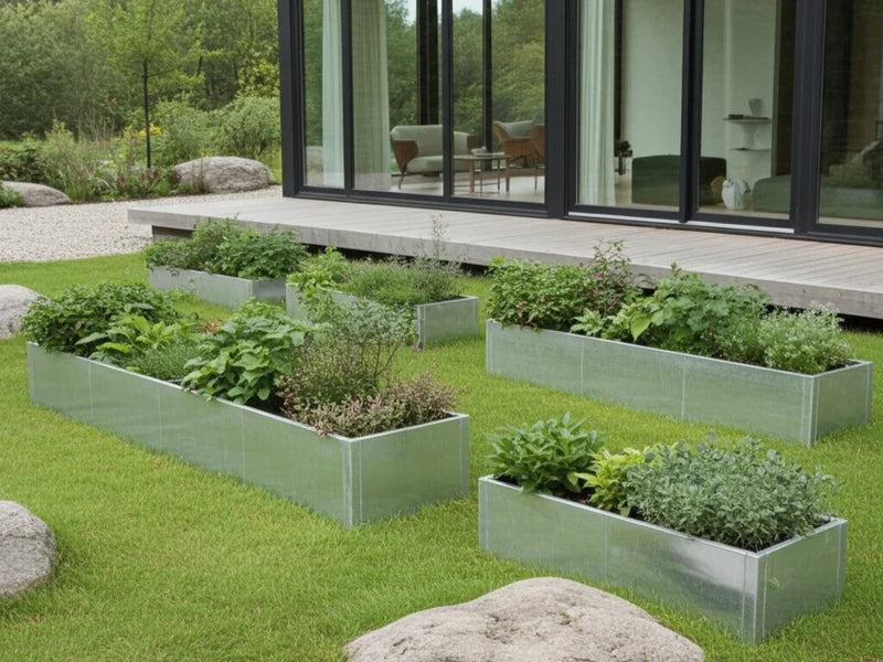 Flera odlingslådor i galvaniserat stål med grönsaker i trädgård